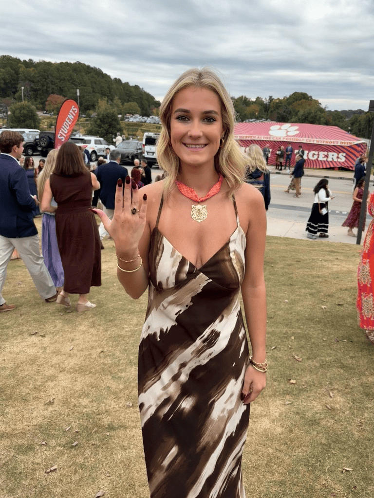 Carsin Aull outdoors at an event, smiling